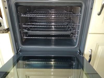 open oven that is clean showing the oven racks