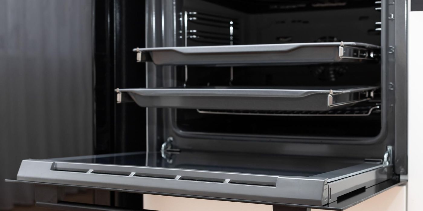 open oven cavity with double oven shelves pulled out